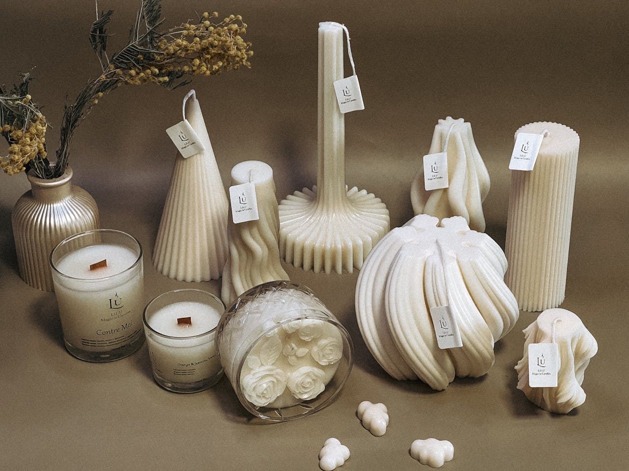 A collection of intricately designed sculpted candles in various shapes, perfect for decor.